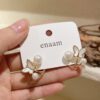 Earrings_held_in_hand_2K_202607021442 Elegant Butterfly Pearl Stud Earrings