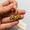 Earrings_held_in_hand_2K_202607021520 Gold Plated Leaf Drop Jhumka Earrings