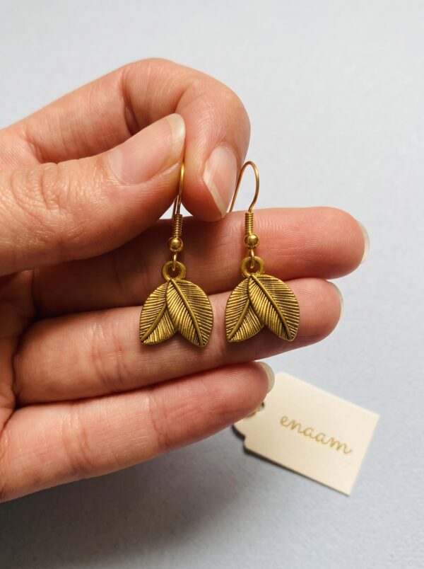 Earrings_held_in_hand_2K_202607021520 Gold Plated Leaf Drop Jhumka Earrings